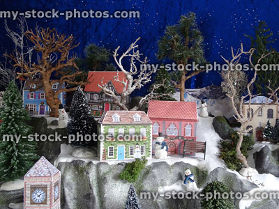 Stock image of Christmas mountain village with fake snow, printed paper houses