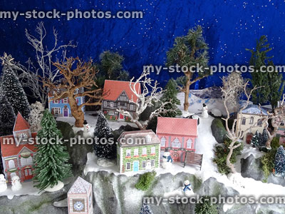 Stock image of homemade Christmas village display, printable card houses, miniature railway trees