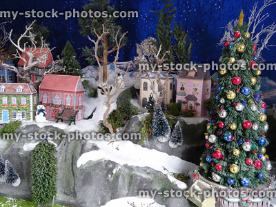 Stock image of miniature village with Christmas tree, paper houses, fake snow