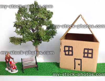 Stock image of small cardboard dolls house, with model tree