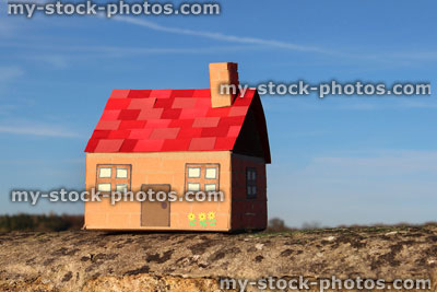 Stock image of cardboard dolls house, with field, tree and sky