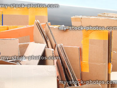 Stock image of flattened cardboard boxes being recycled / waste recycling plant