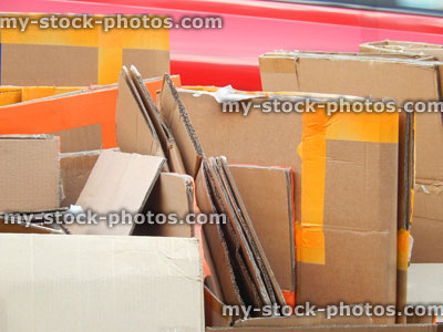 Stock image of flattened cardboard boxes being recycled / waste recycling plant