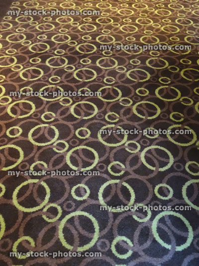 Stock image of hard wearing, short cut pile brown / yellow carpet with pattern of stripes and circles