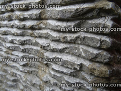 Stock image of grey granite stone fountain with carved straight lines