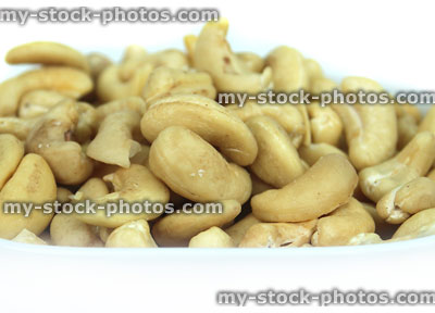 Stock image of cashew nuts, square dish of cashews, healthy eating snacks