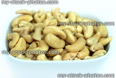 Stock image of cashew nuts / seeds, dish of cashews, healthy snack food