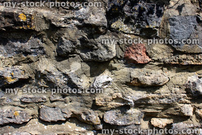 Stock image of rustic cobblestone wall, with pointed irregular stones