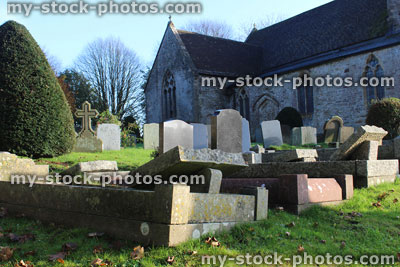Stock image of neglected RIP gravestones, church graveyard cemetery, leaning / falling over