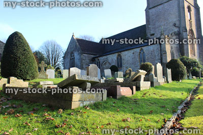 Stock image of neglected RIP gravestones, church graveyard cemetery, leaning / falling over