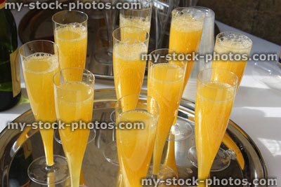 Stock image of silver tray of champagne glasses, orange juice / bucks fizz, wedding reception