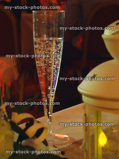 Stock image of sparkling wine in glass / champagne flute, metal lantern