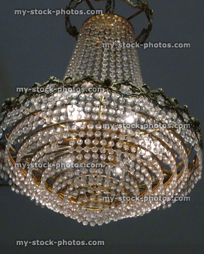 Stock image of antique drape style crystal chandelier light fitting, brass, glass crystals