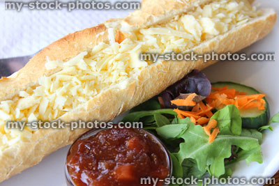 Stock image of cheese sandwich / baguette, salad, picket, grated Cheddar cheese