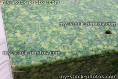 Stock image of Sage Derby cheese block, mottled green cheese, spinach herbs