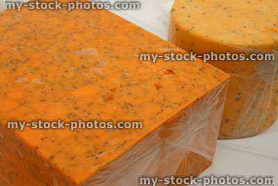 Stock image of mottled orange cow's milk blue cheese blocks, Shropshire blue cheeses, orange colour