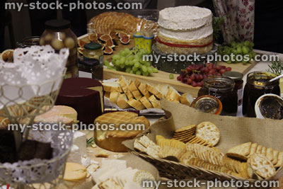 Stock image of cheese board with brie, Stilton, Cornish Yarg, Cheddar, crackers, savoury biscuits
