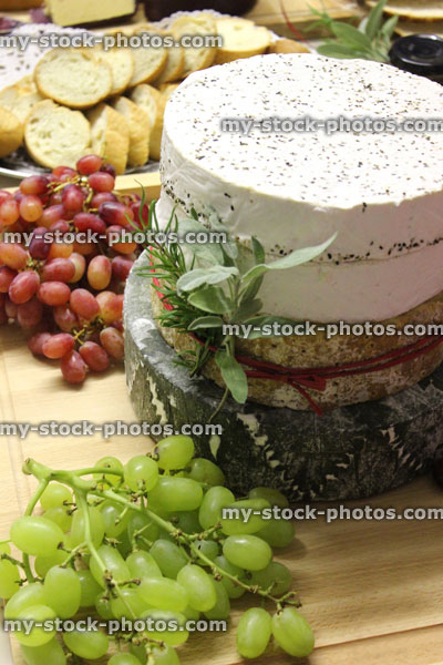 Stock image of stack of cheeses / Stilton, brie cheese cake on wooden board