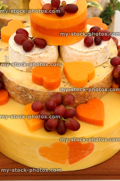 Stock image of cheese wedding cake, decorated cheese cake, Cheddar, Red Leicester, brie, grapes