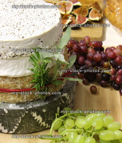 Stock image of stack of cheeses / cheese cake on wooden board
