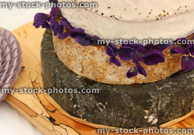Stock image of stack of cheeses / cheese cake on wooden board