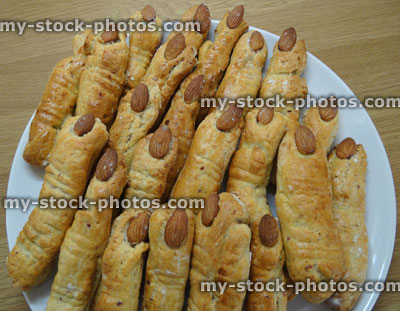 Stock image of cheese straws shaped like fingers, with almond fingernails