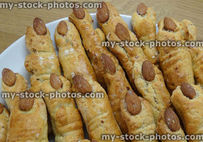 Stock image of cheese straws shaped like fingers, with almond fingernails