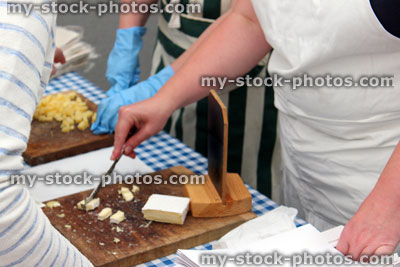 Stock image of brie and Cheddar cheese cut into small pieces, tasting samples