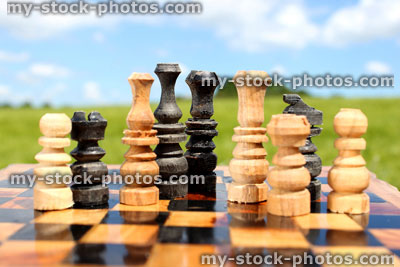Stock image of chessboard game / wooden chess set against sky, boardgame