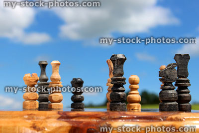 Stock image of chessboard game / wooden chess set against sky, boardgame