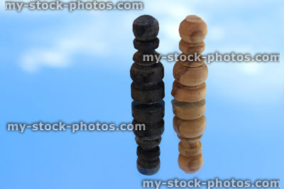 Stock image of chess pieces reflected against sky (single black and white pawns)