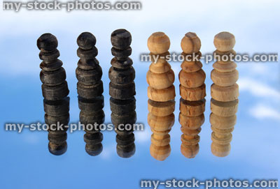 Stock image of wooden chess pieces reflected against sky / chess set reflection / floating