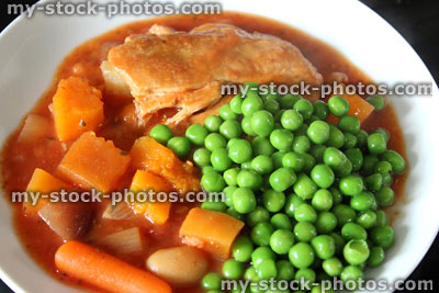 Stock image of chicken casserole meal with fresh garden peas, vegetables