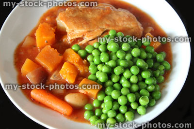 Stock image of chicken casserole meal with fresh garden peas, vegetables