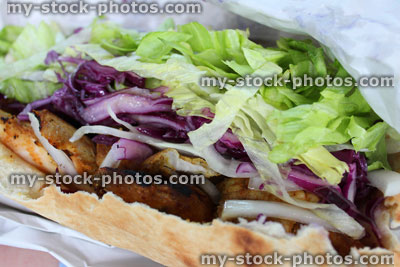 Stock image of chicken shish kebab / kebob, lettuce, pitta bread, takeaway