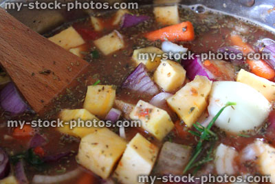 Stock image of chicken stew / vegetable casserole cooking in saucepan / pan, vegetable soup