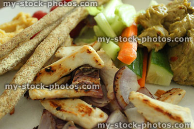 Stock image of light lunch, wholemeal breadsticks, fried chicken strips, hummus, raw vegetables