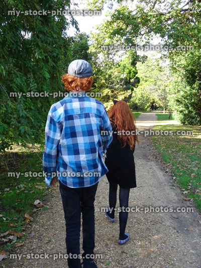 Stock image of boy and girl walking along woodland pathway / footpath, red hair ginger