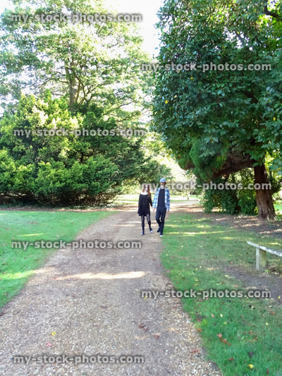 Stock image of boy and girl walking along woodland pathway / footpath, red hair ginger