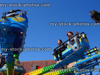 Stock image of children enjoying roundabout funfair ride on Brighton Pier