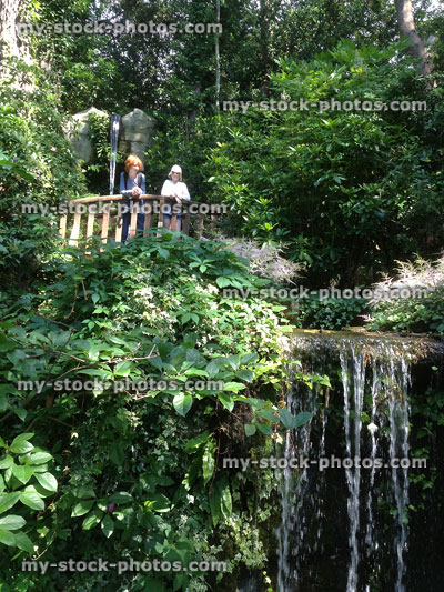 Stock image of two children stood on a viewing platform over a waterfall