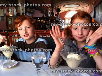 Stock image of two children eating ice cream in an Indian Restaurant