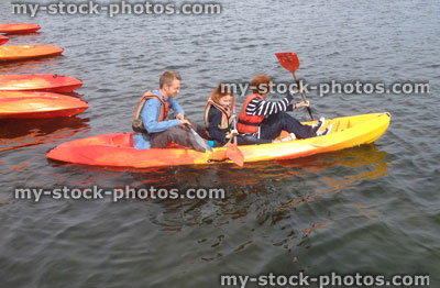 Stock image of family on kayak, water sports, father, son, daughter