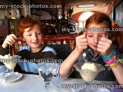 Stock image of children eating ice cream in an Indian Restaurant