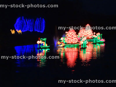 Stock image of Chinese Lantern Festival lights, illuminated Lotus flowers, lake reflection