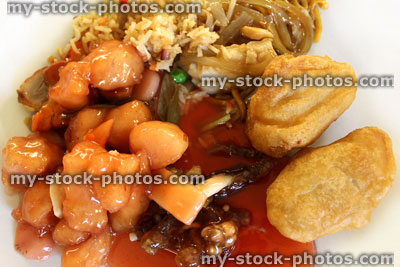Stock image of Chinese takeaway selection on white plate, sweet and sour sauce