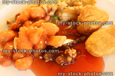 Stock image of Chinese takeaway selection on white plate, sweet and sour sauce