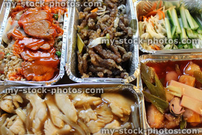 Stock image of Chinese takeaway dishes in aluminium foil food containers