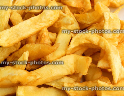 Stock image of greasy chips from takeaway fish and chip shop