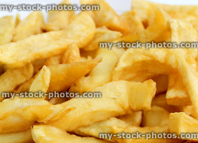 Stock image of greasy chips from takeaway fish and chip shop